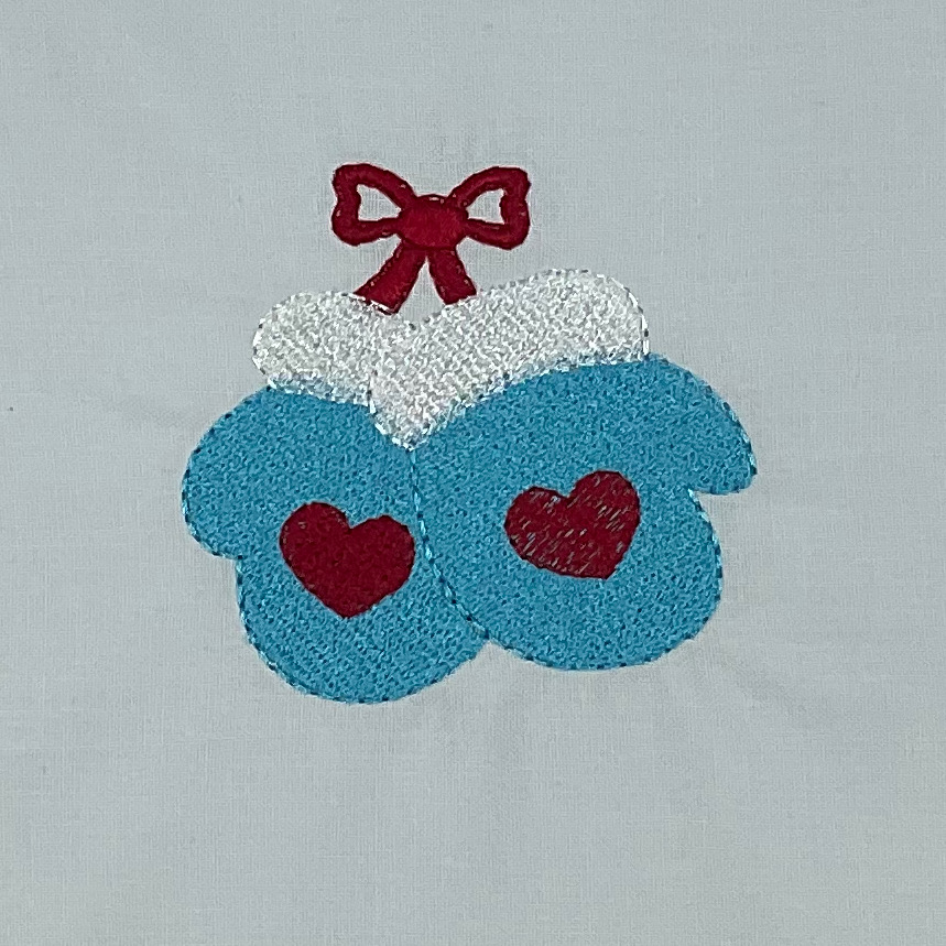 Blue mittens with hearts and red bow.